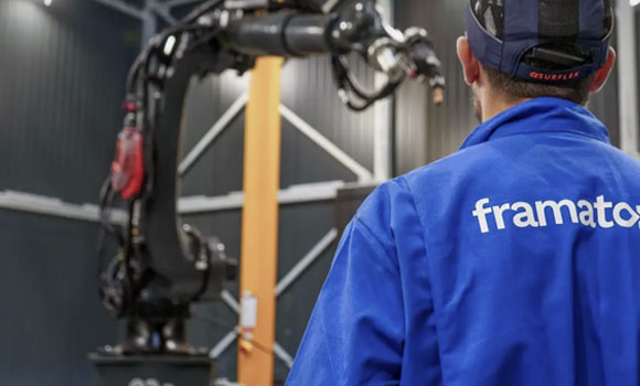 Wire-fed robotic additive manufacturing cell